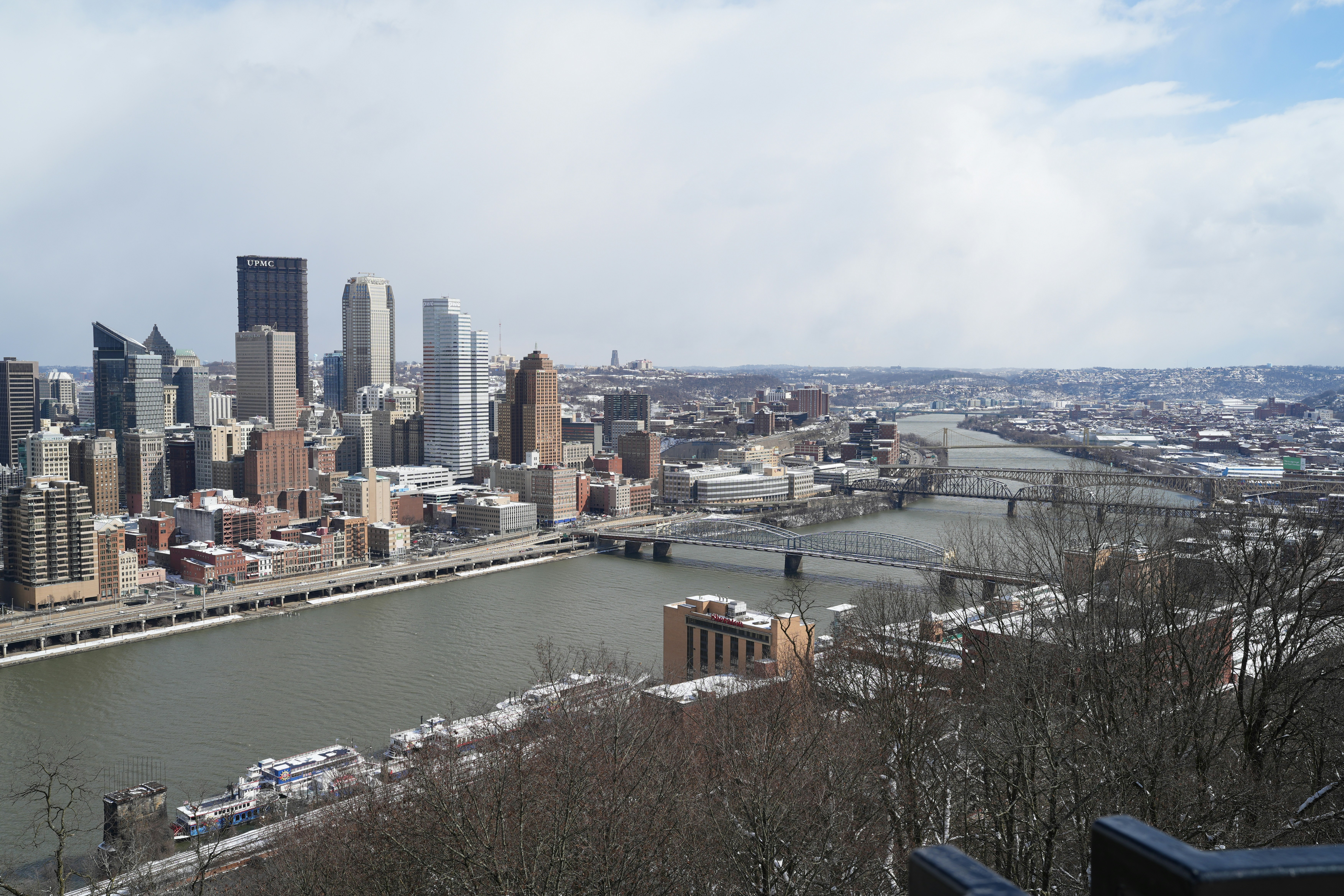A view of a city and a river from a hill